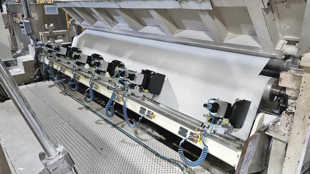 Retrofitted rewinder in production with new Helios Slitting module.